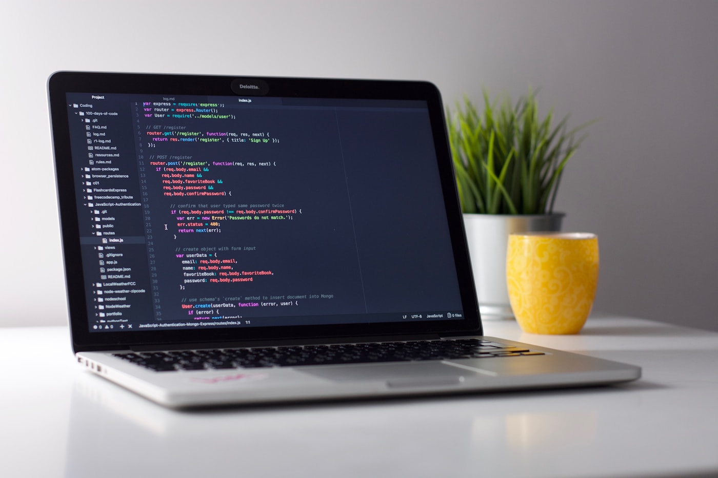 Laptop with IDE on desk, symbolizing isolated macOS builds for Swift concurrency migration